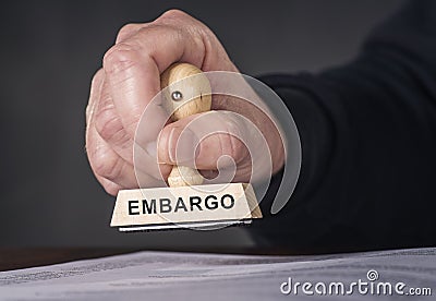 Hand and stamp with inscription embargo Stock Photo