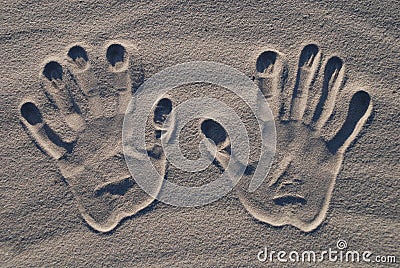 Hand stamp on the sand Stock Photo