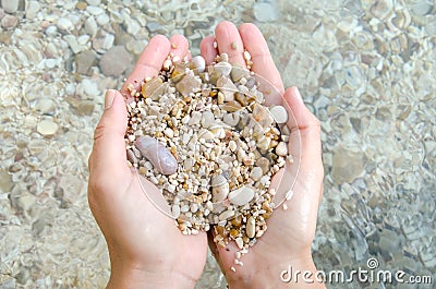 giving smooth zen pebble in hand conceptual and inspirational Stock Photo