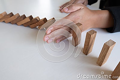 Woman hand stop blocks wood protect other, Concept Prevent failures from spreading to other business Stock Photo