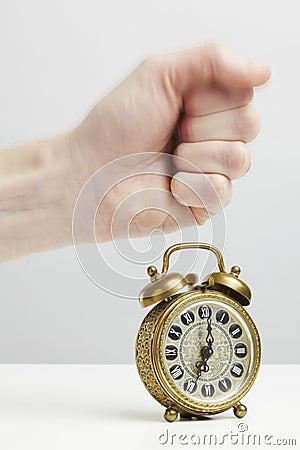 Hand stopping alarm on clock Stock Photo