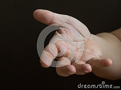 Outstretched hand on a dark background Stock Photo