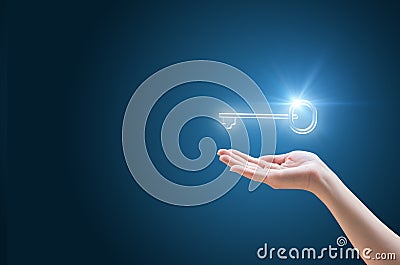 Hand supports the Key to success in business Stock Photo