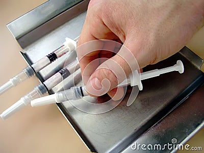 Hand with syringes... Stock Photo