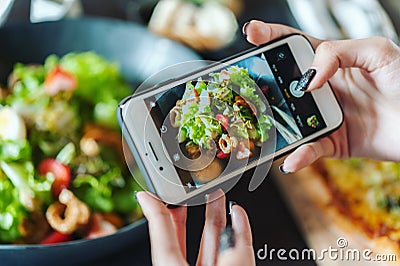 Hand taking photo of salad Stock Photo