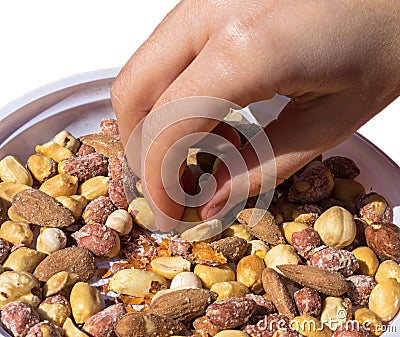 Hand taking some mixed snacks rice crackers, nuts and dried fruits Stock Photo