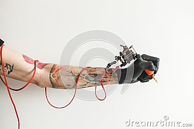 Hand tattoo artist with the tattoo machine Stock Photo