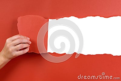 Hand tearing red paper background uncovering white copy space Stock Photo