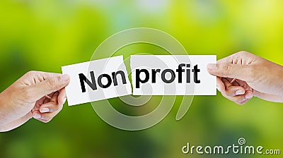 Hand tearing the word Nonprofit for Profit Stock Photo