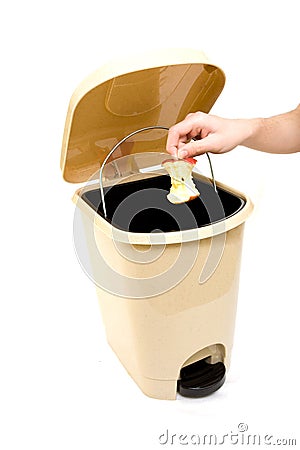 Hand throwing apple in trash Stock Photo