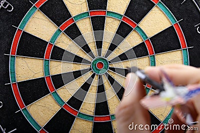 Hand throwing dart Stock Photo