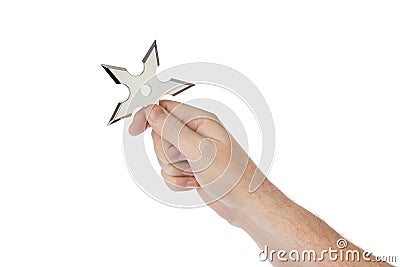 Hand is throwing ninja shuriken Stock Photo