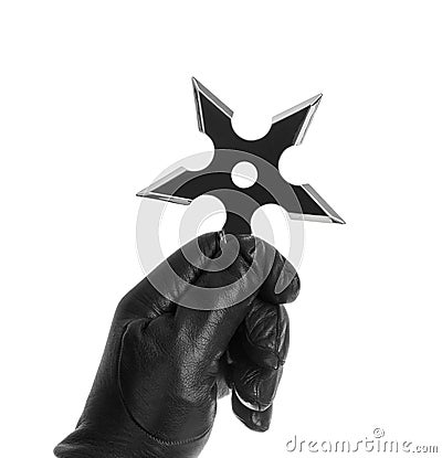 Hand is throwing ninja shuriken Stock Photo