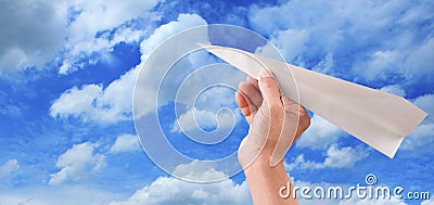 Hand throwing papaer plane to blue sky seem freedom Stock Photo