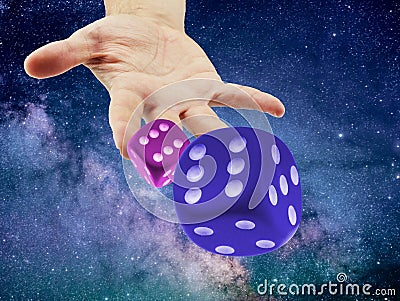 Hand Throwing or rolling Dice in the cosmo or universe. Causality or randomness concept Stock Photo