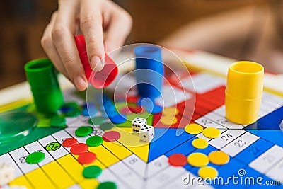 Hand throwing two dices playing Parcheesi, Parchis game Stock Photo