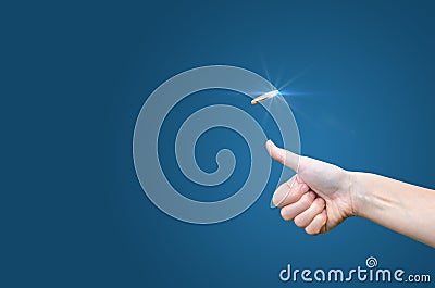 Hand throws a coin on a blue background to make the decision Stock Photo