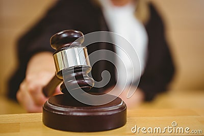 Hand about to bang gavel on sounding block Stock Photo