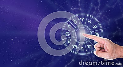 Hand touching an astrology chart with all the zodiac signs Stock Photo