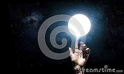 Hand touching the moon Stock Photo