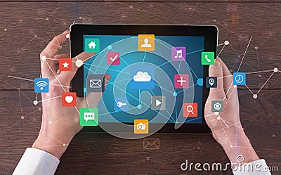 Hand using multitask tablet with application symbols and icons concept Stock Photo