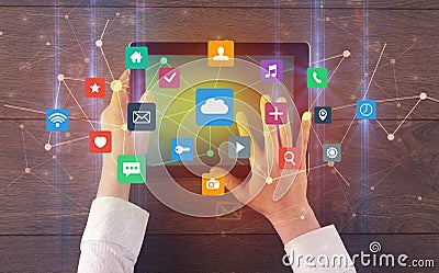 Hand using multitask tablet with application symbols and icons concept Stock Photo