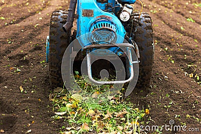 A hand tractor, motor block turning up soil Stock Photo