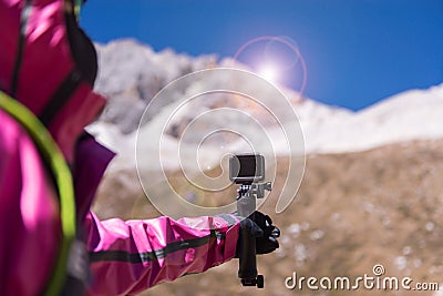Hand traveler woman holding action camera at snow mountain,Navigation for travel,Close up Stock Photo