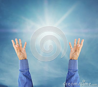 Hand trying to reach on the sky with sunshine rays Stock Photo