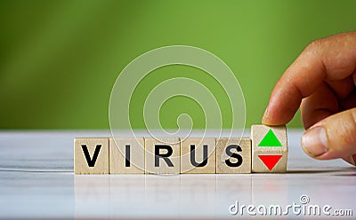 Hand turn wooden cube block with virus word. Coronavius Stock Photo
