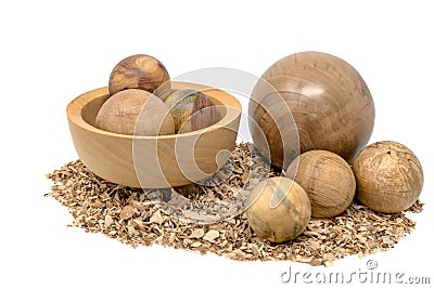 Hand-turned wooden balls in a bowl decorated with sawdust Stock Photo