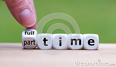 Hand is turning a dice and changes the word `full-time` to `part-time` Stock Photo