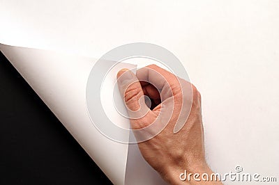 Hand turning paper Stock Photo