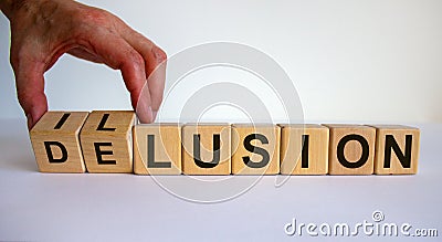 Hand turns a cube and changes the word delusion to illusion. Beautiful white background. Business concept. Copy space Stock Photo