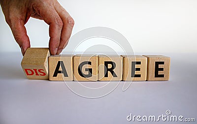 Hand turns a cubes and changes the expression `disagree` to `agree`. Beautiful white background. Business concept, copy space Stock Photo