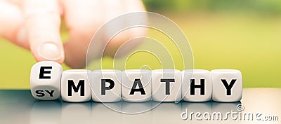 Hand turns dice and changes the word `sympathy` to `empathy`. Stock Photo