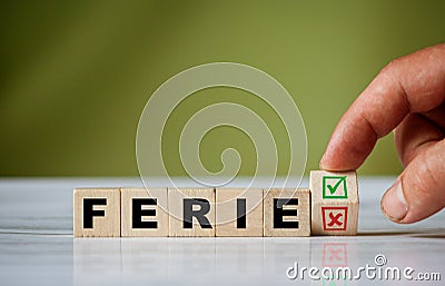 Hand turns the wooden cube and changes the polish word FERIE english winter holidays with green positive tick check box and red Stock Photo