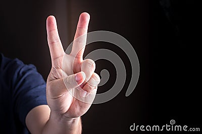 Hand with two fingers up. sigh of peace or victory. Also the sign for the letter V in sign language. studio lights Stock Photo