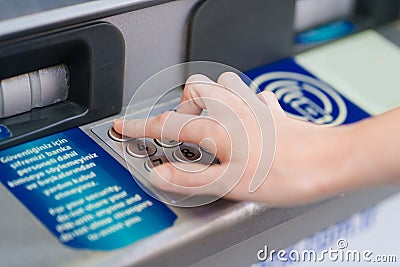 the hand types the pin code on the ATM keyboard. Stock Photo