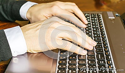Hand typing on laptop keyboard closeup. Businessman using a laptop computer. Stock Photo