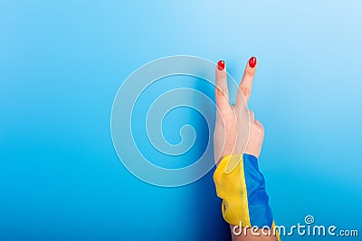 the hand Ukrainian woman with national Ukraine flag on her hand. Patriotism and love for the country. stop war concept Stock Photo