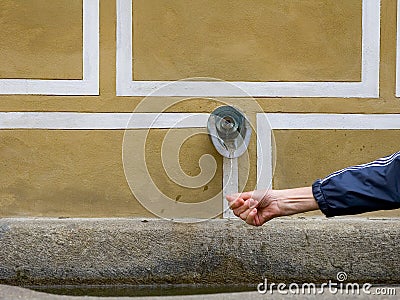 Hand under waterwater spout in europe Stock Photo