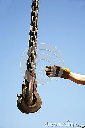 Hand of unknown worker with industrial crane chains Stock Photo