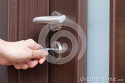 Hand unlocking house door Stock Photo
