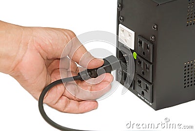 Hand unplug out from the socket Stock Photo