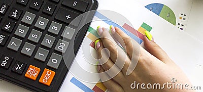 Hand of unrecognizable businessman using calculator - closeup shot Stock Photo