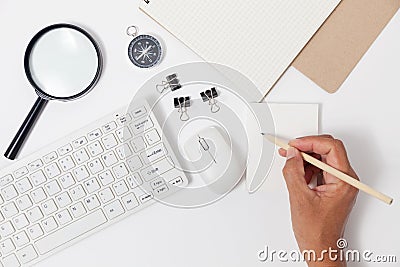 Hand use pencil writing on white paper note and business objects Stock Photo