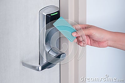 Hand using electronic smart contactless key card for unlock door in hotel or house Stock Photo