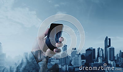 Hand using mobile smart phone with double exposure modern city background, Communication and network connection technology Stock Photo