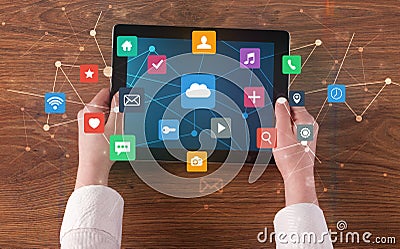 Hand using multitask tablet with application symbols and icons concept Stock Photo